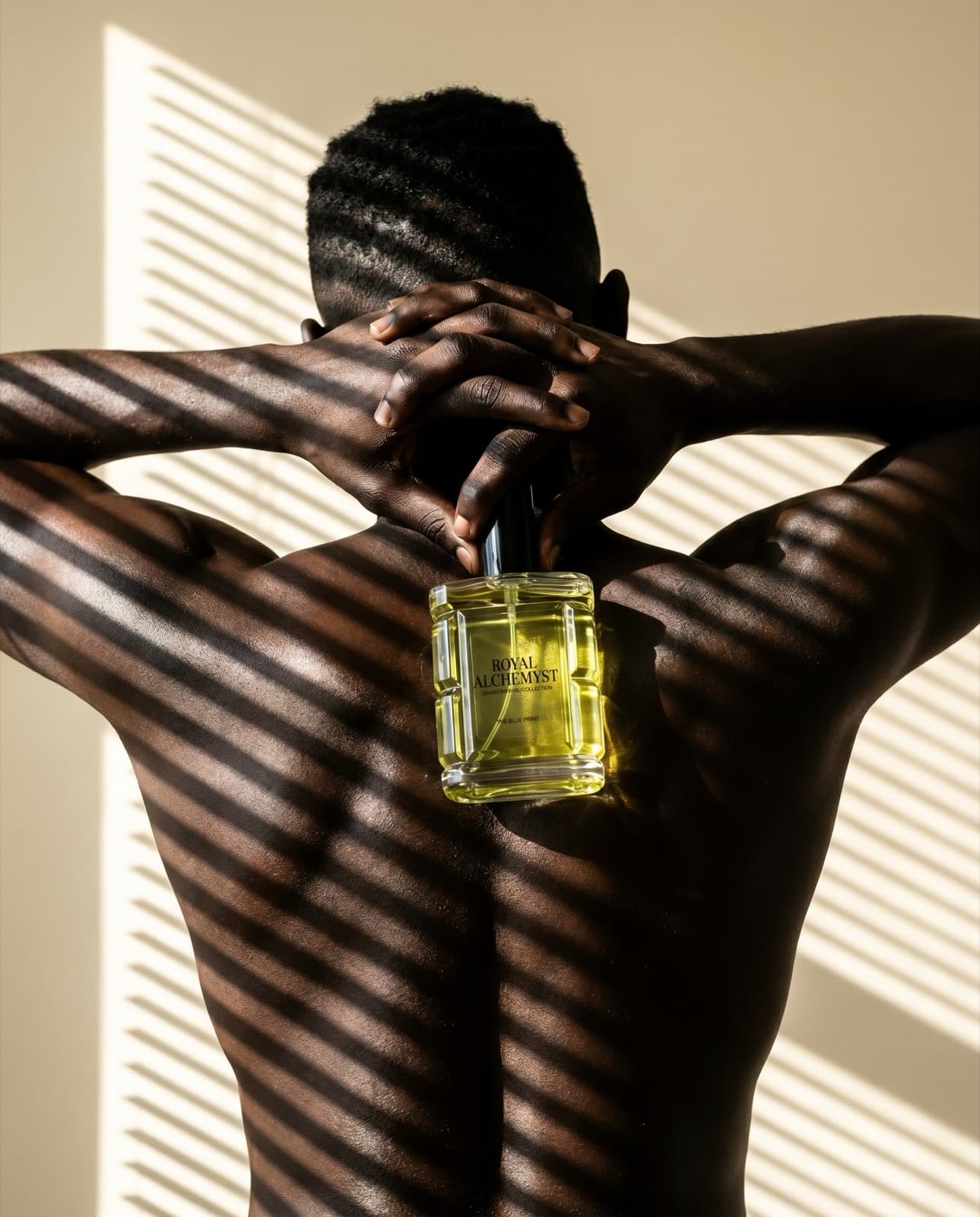 A model holding a Royal Alchemyst body oil, lit through window blinds
