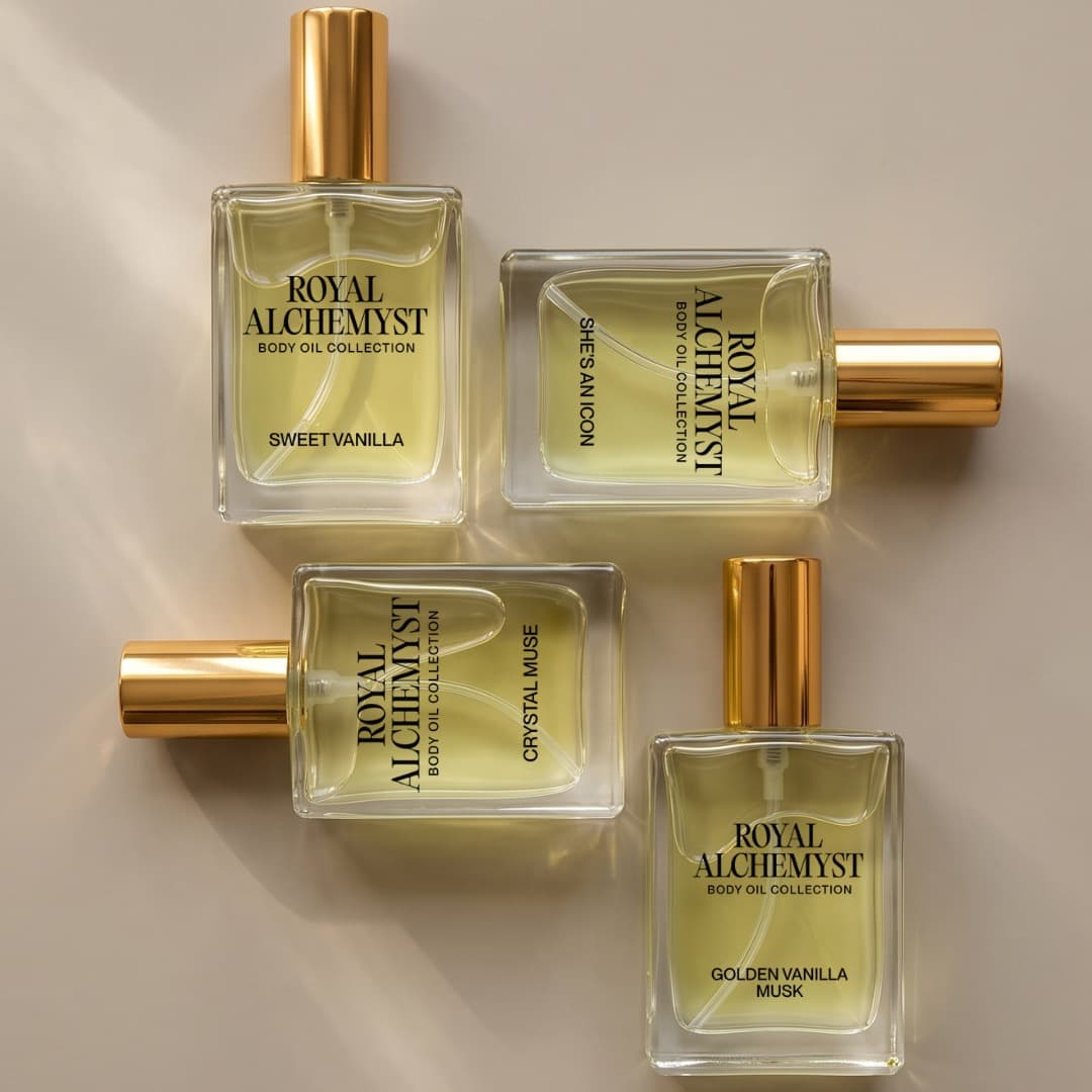 Four Royal Alchemyst travel-size body oil bottles